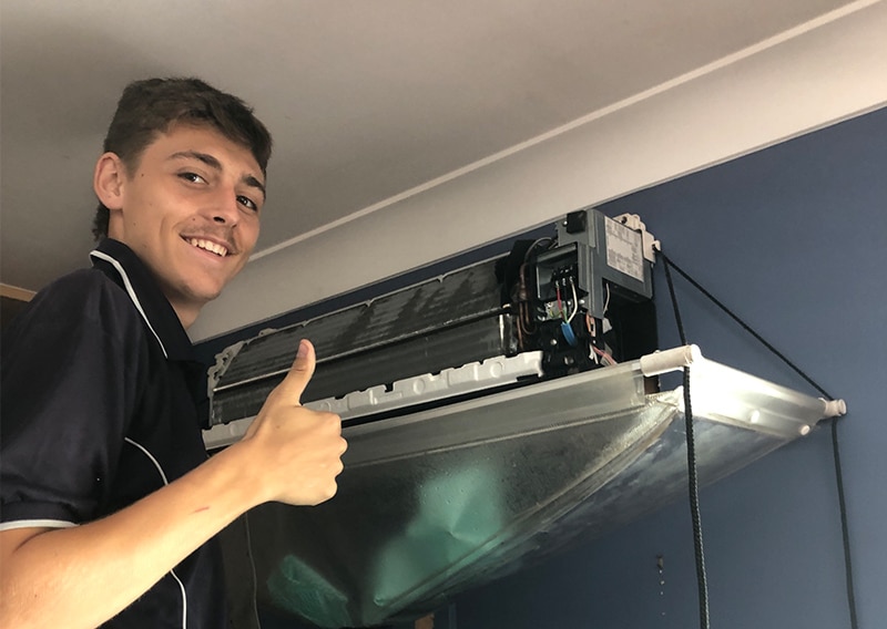 Technician Fixing the Air-Conditioner — Air-Conditioning and Refrigeration in Sunshine Coast, QLD