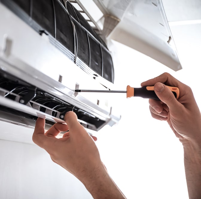 Electrician repairing air conditioner indoors — Air-Conditioning and Refrigeration in Caloundra, QLD