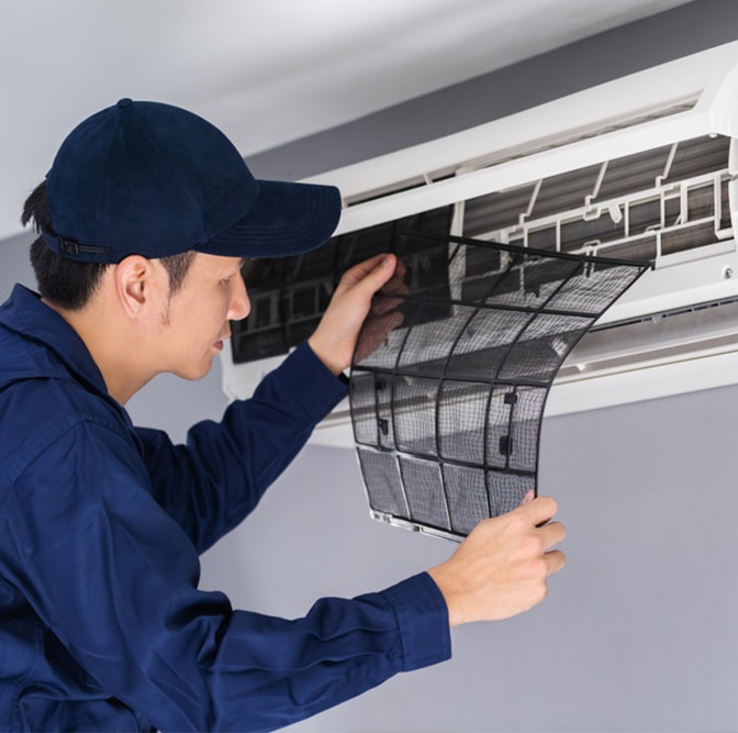 Technician service removing air filter — Air-Conditioning and Refrigeration in Maroochydore, QLD