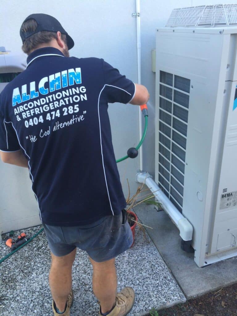 Man Servicing An Air Conditioning Unit